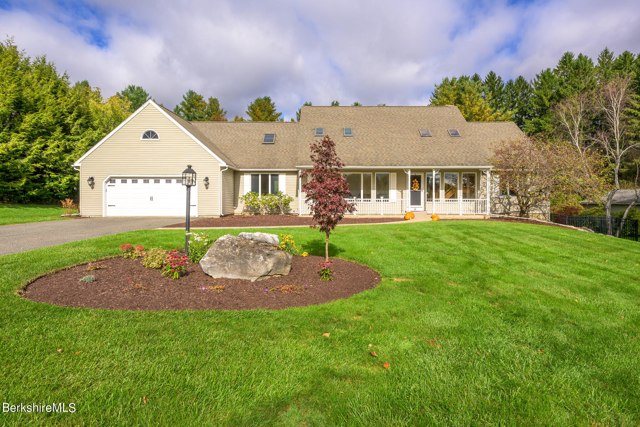 a front view of a house with garden