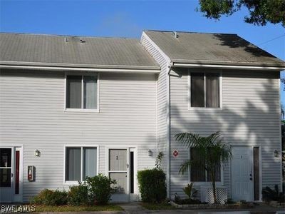 a front view of a house with plants