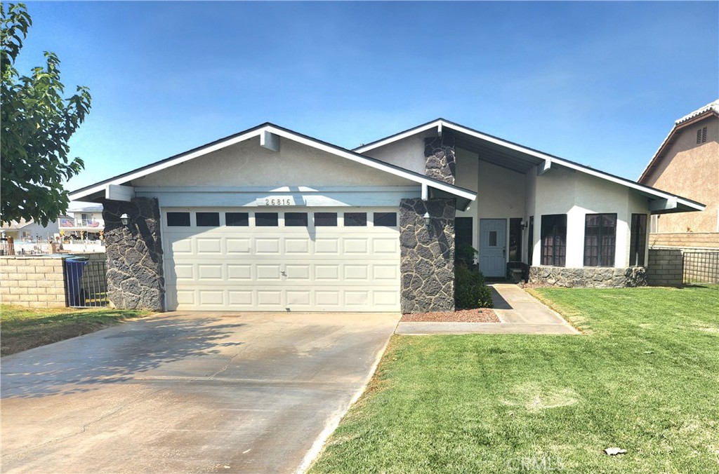 a front view of a house with yard and garage