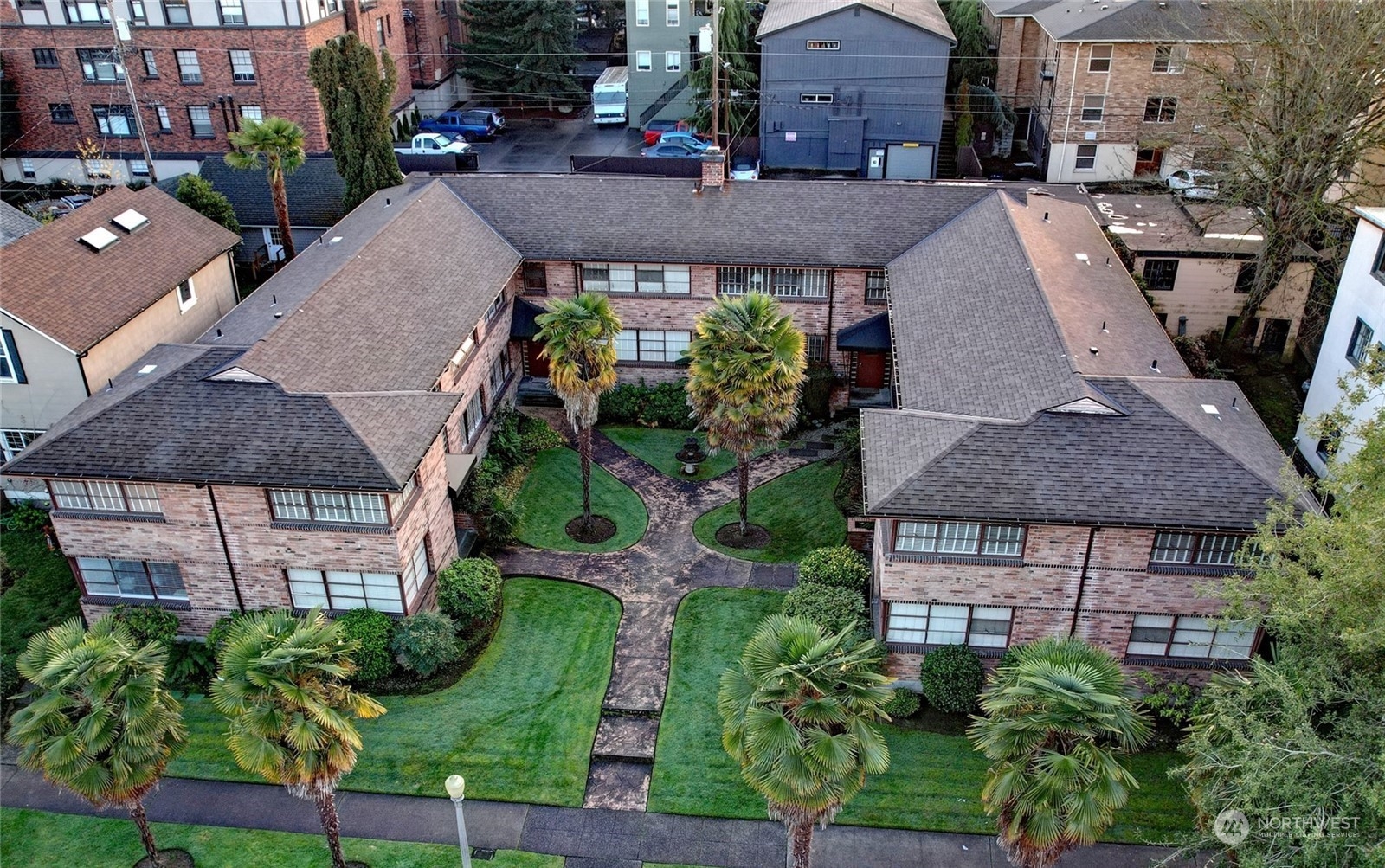 an aerial view of a house with a yard and potted plants