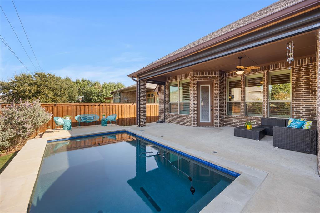 a view of a patio with swimming pool table and chairs