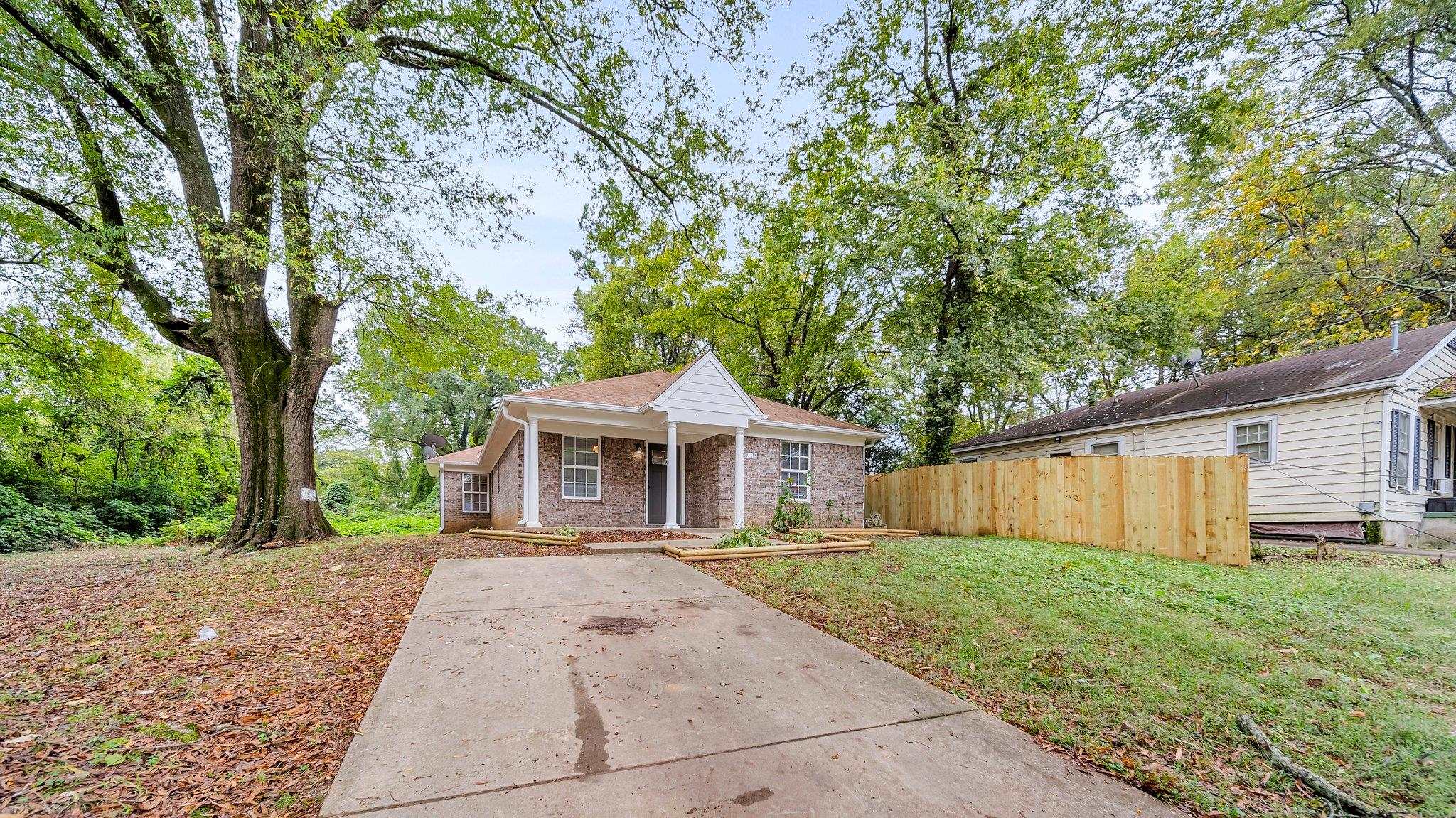 a front view of house with yard and green space