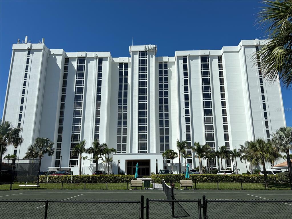 a front view of a building with a yard