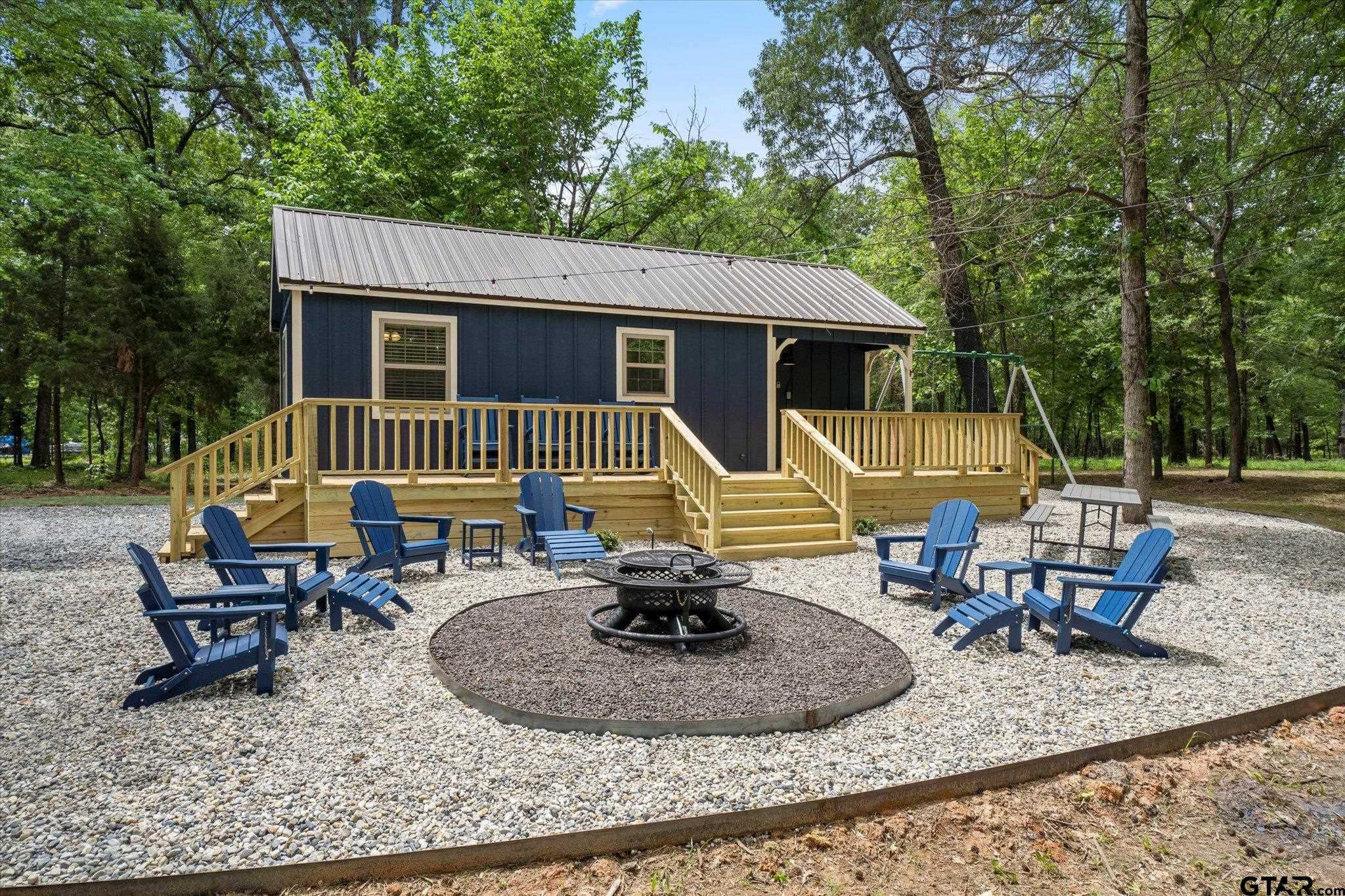 a view of a house with backyard porch and sitting area