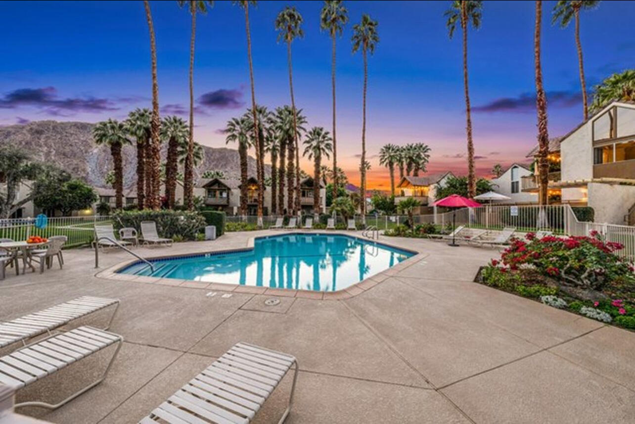 a view of a swimming pool with a lounge chairs