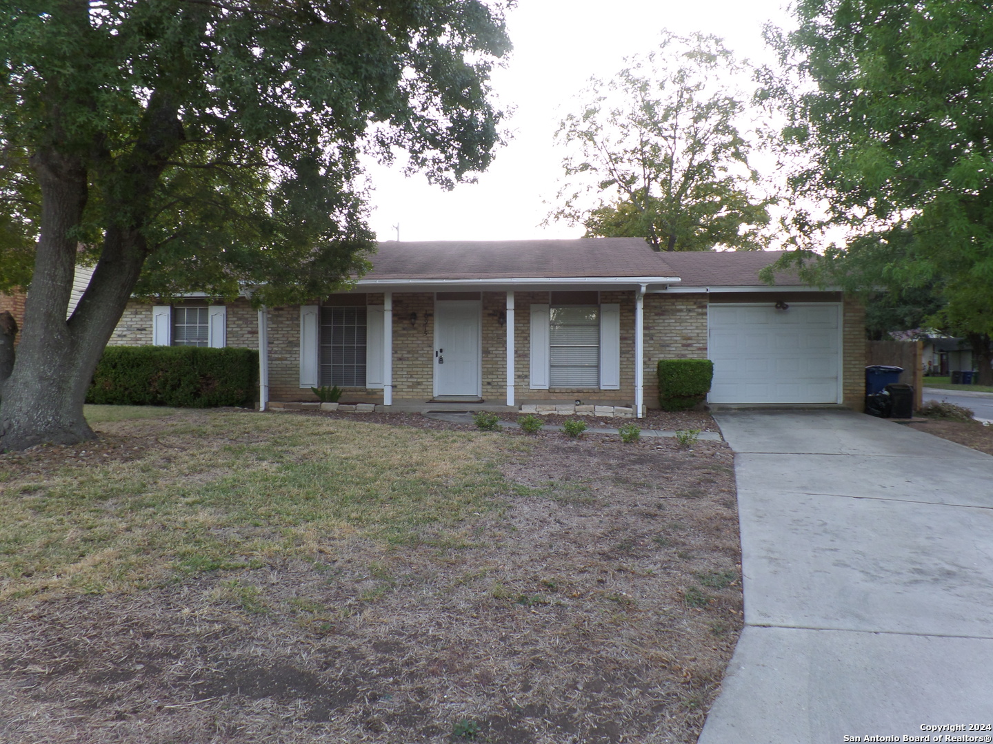 a front view of house with yard and trees