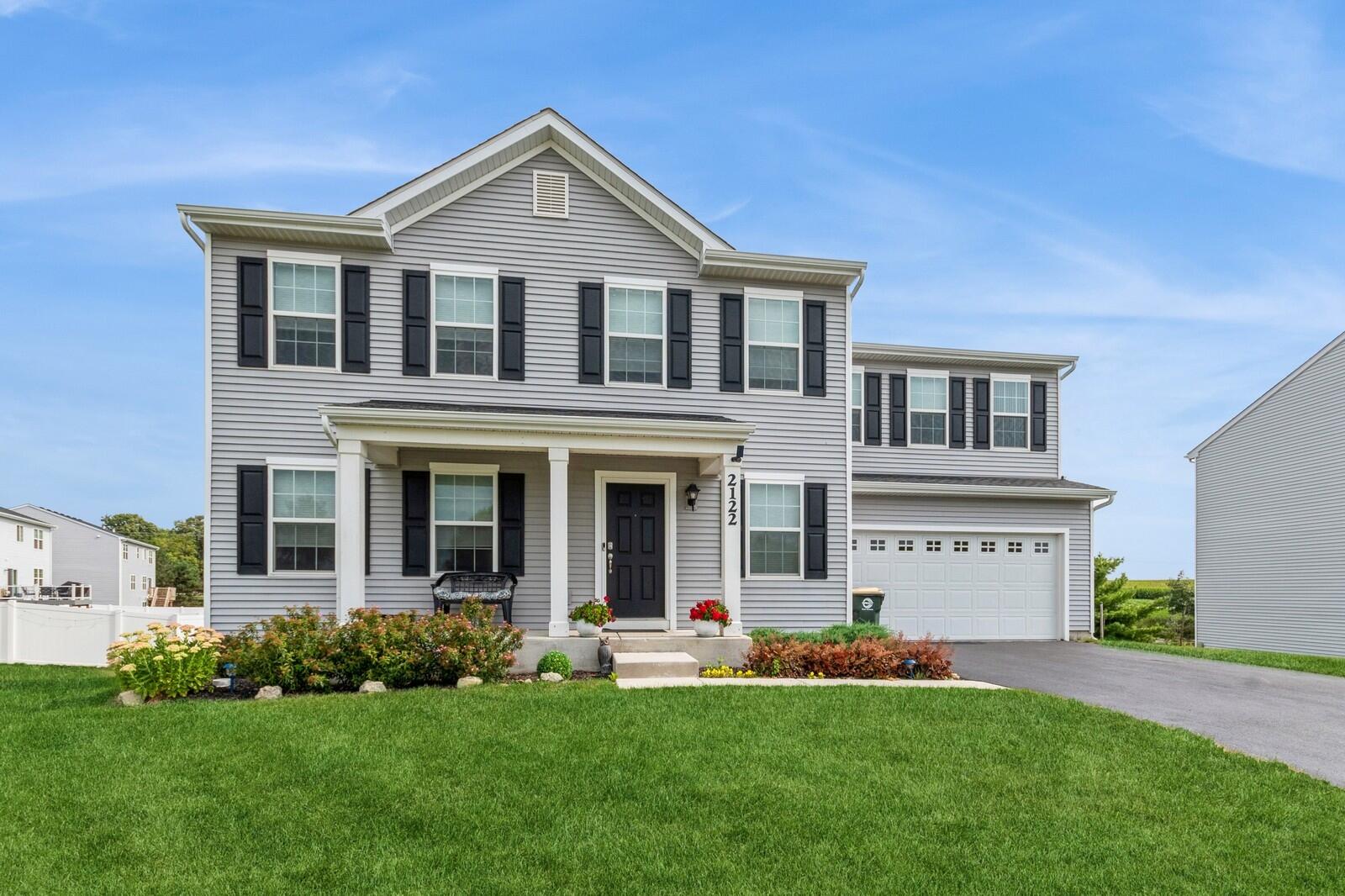 a front view of a house with a yard and garage