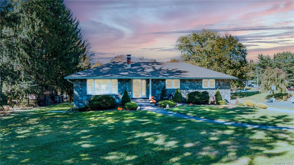 Ranch-style home featuring a yard