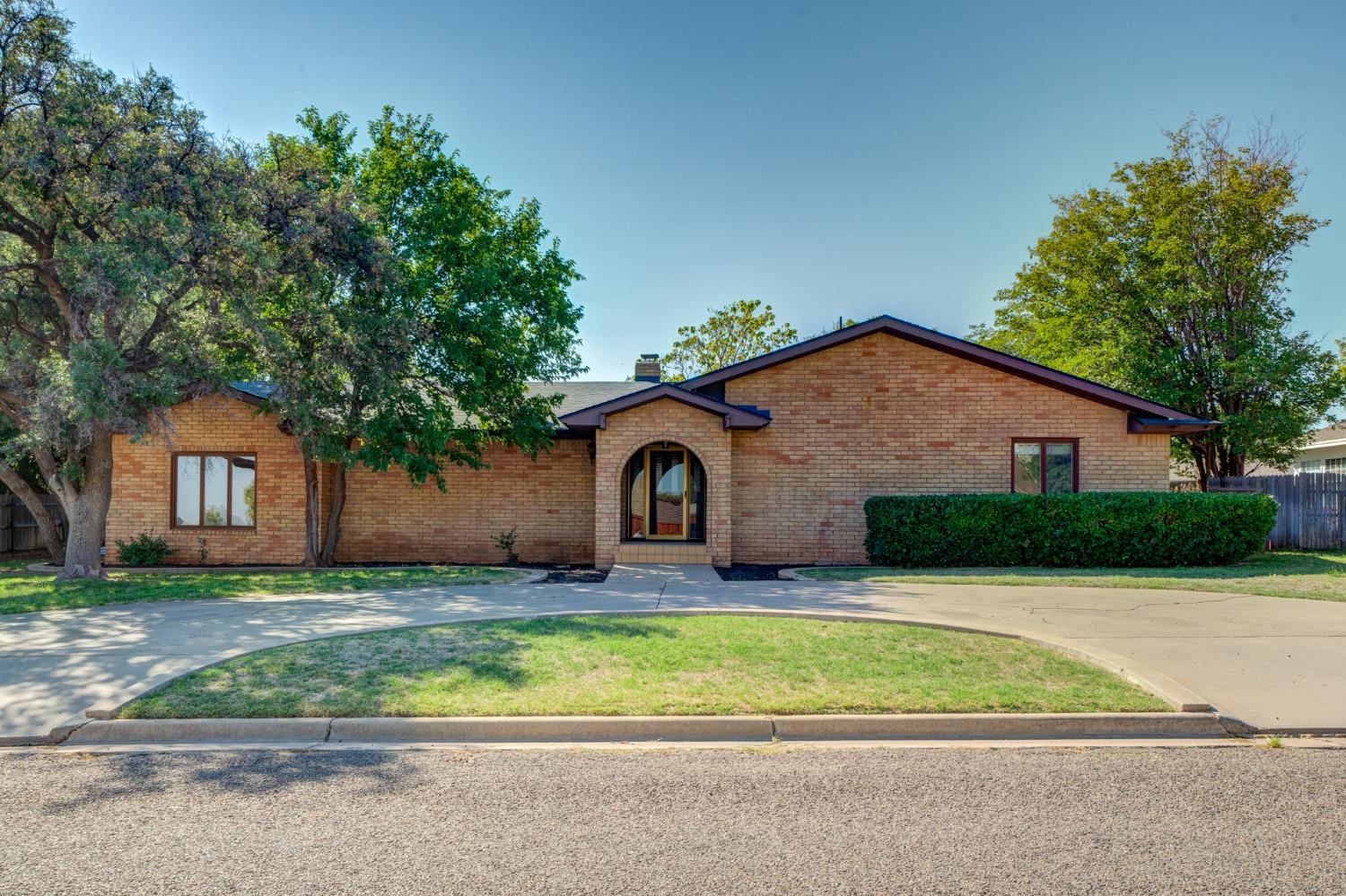 a front view of house with yard and trees