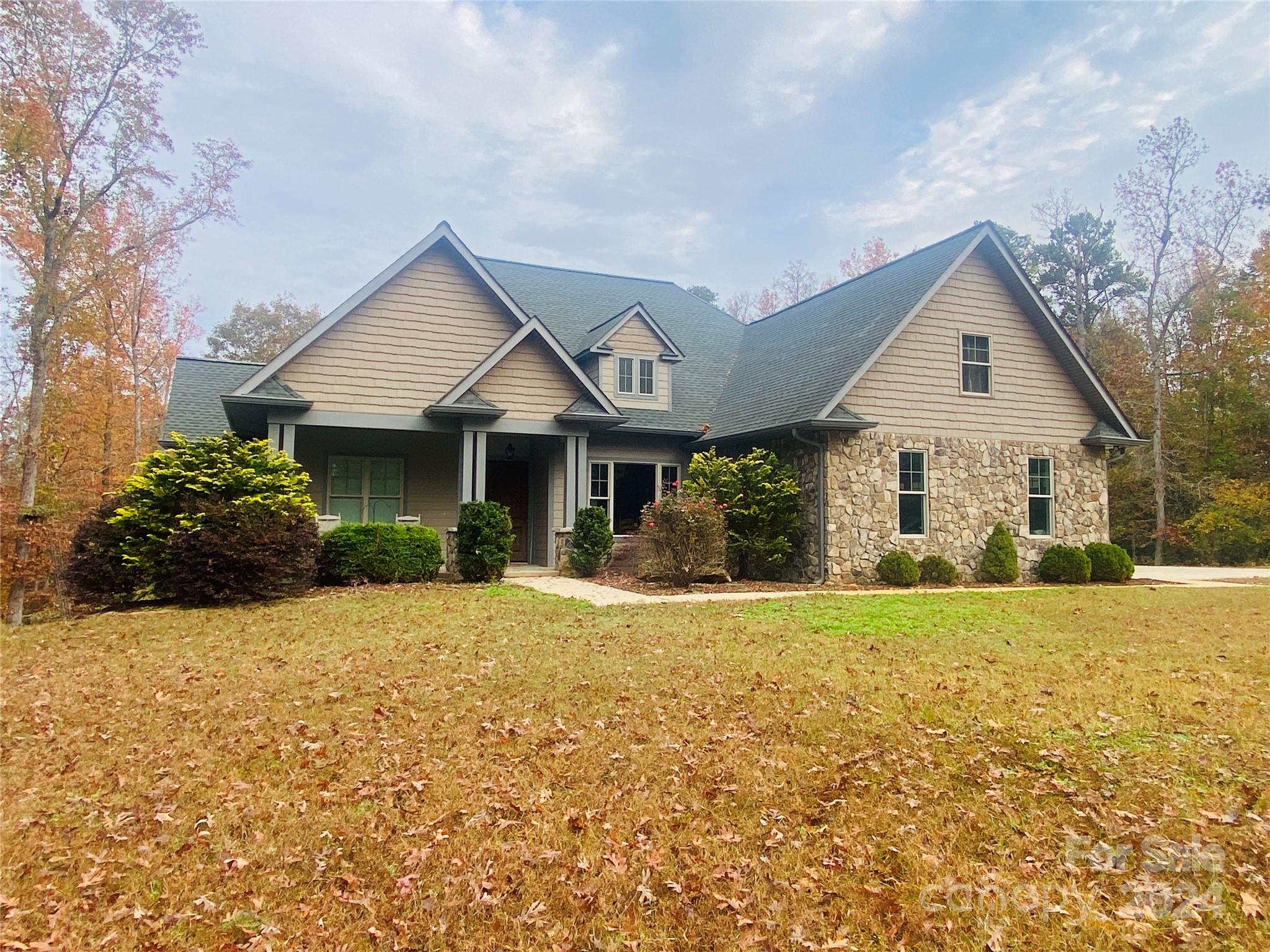 a front view of a house with a yard and porch