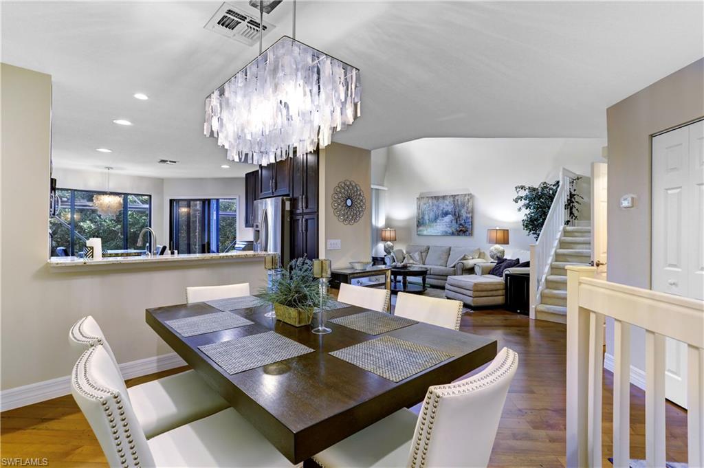 a view of a dining room with furniture and chandelier