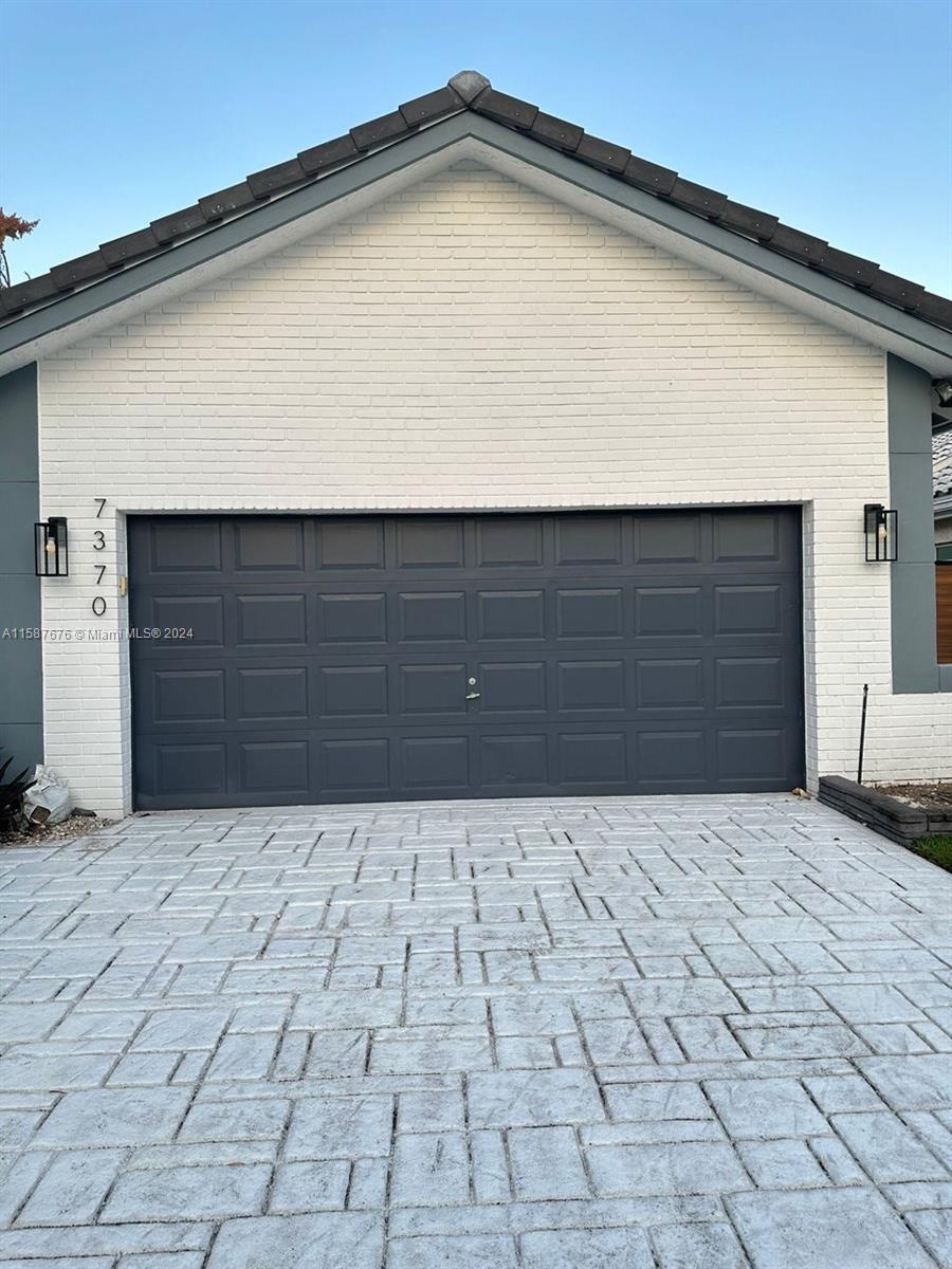 a front view of a house with garage