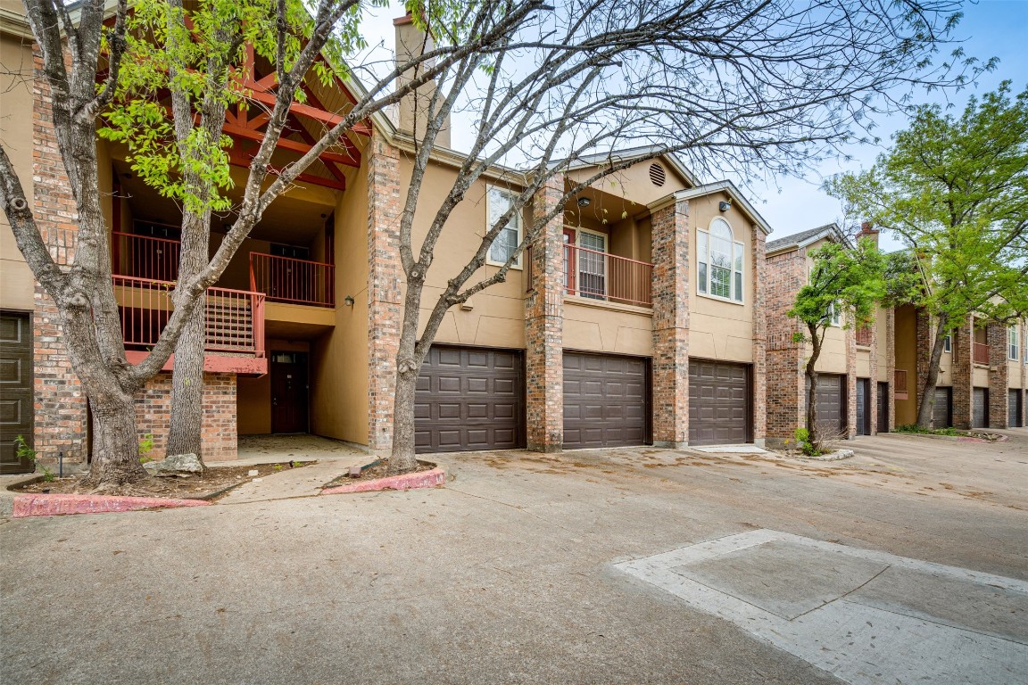 a front view of a house with a tree