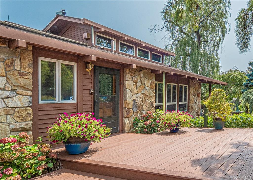 a flower garden is sitting in front of a house