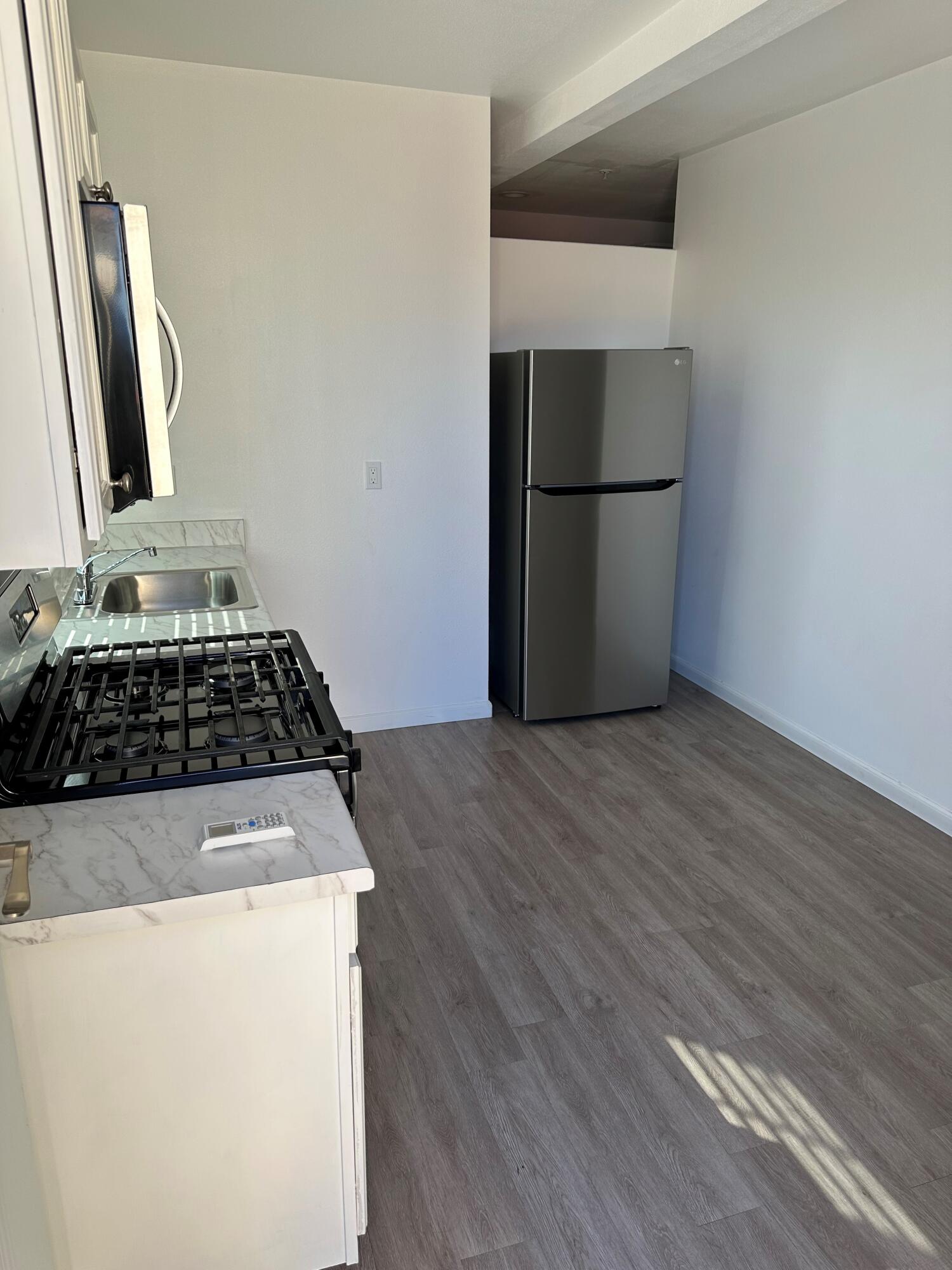 a kitchen with a refrigerator and a stove