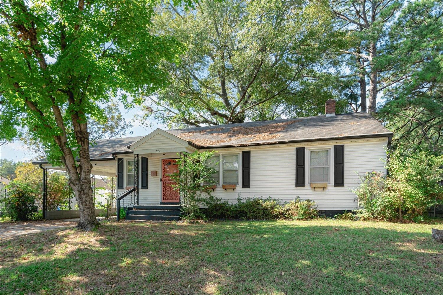 a front view of house with yard and trees