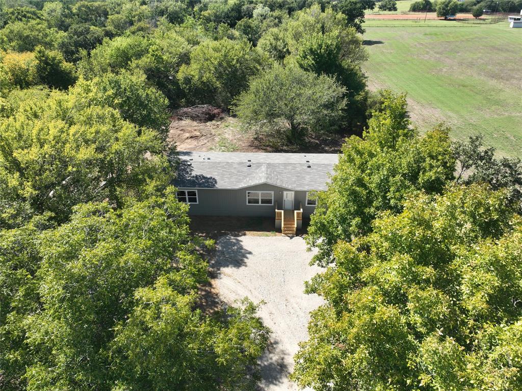 an aerial view of a house with pool yard outdoor seating and yard