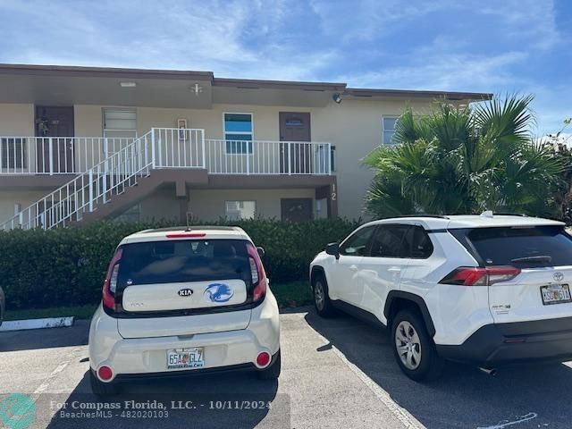 a front view of a house with parking space