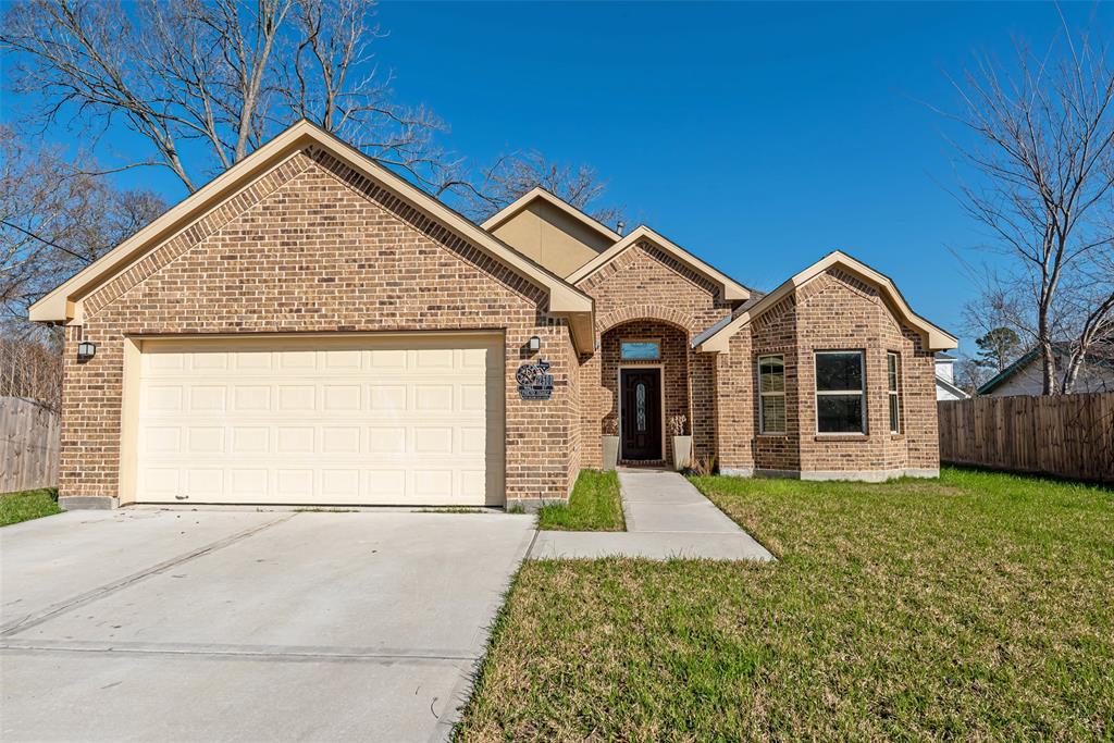 a view of a house with a yard and garage