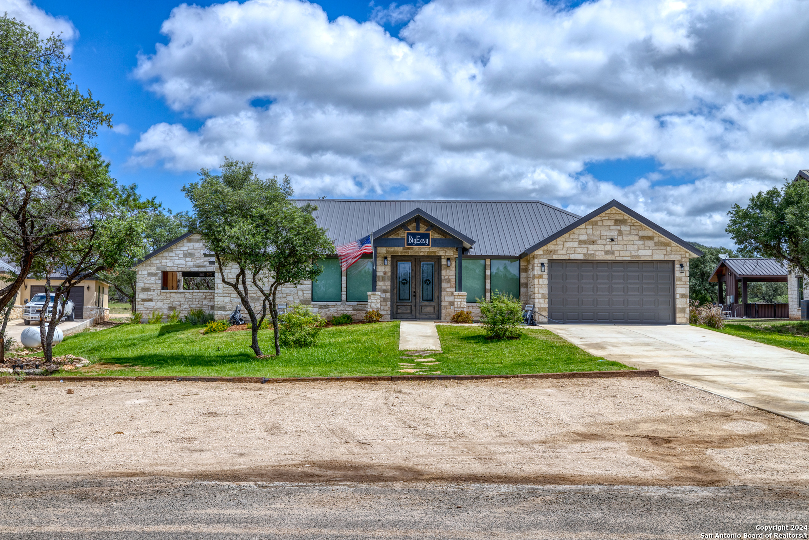 a front view of house with yard and green space