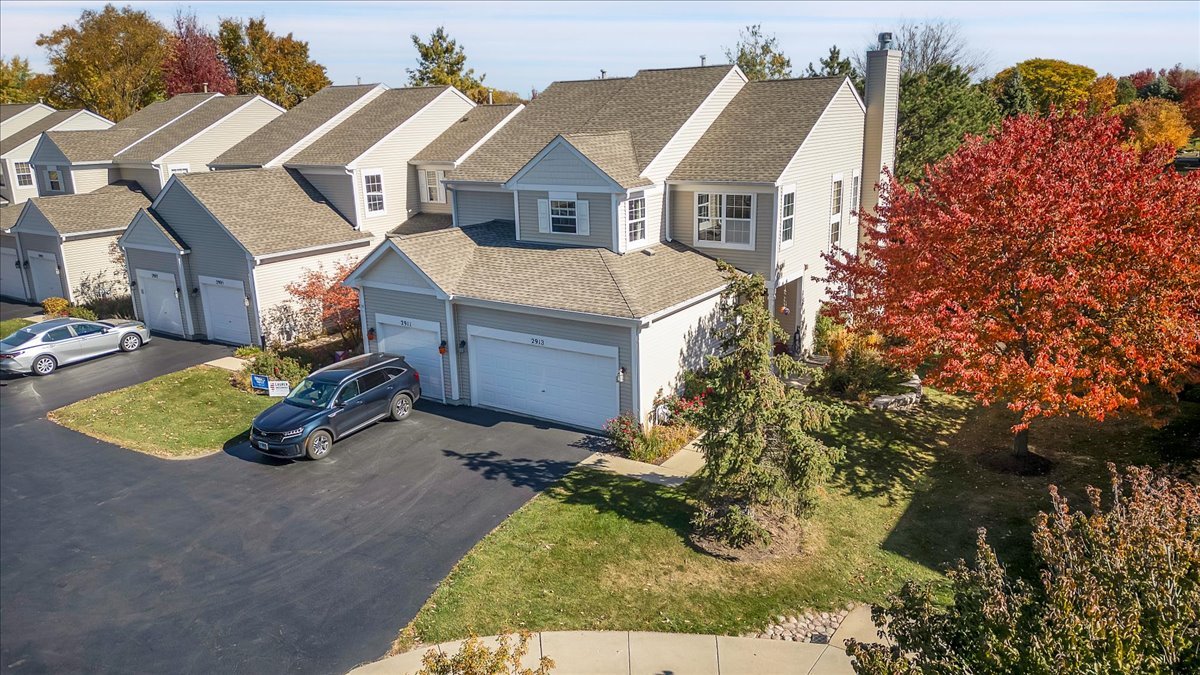 an aerial view of a house with yard