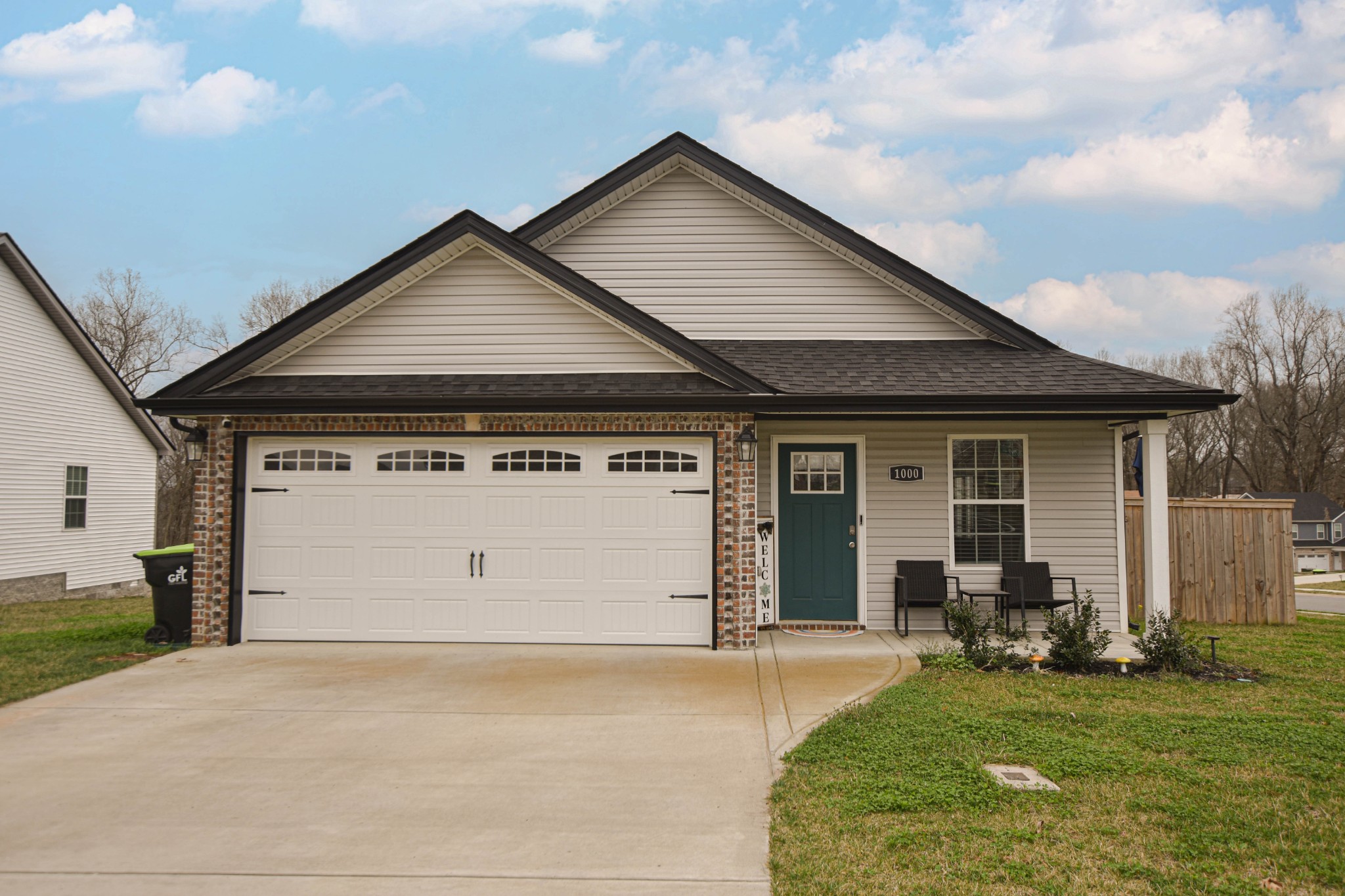 a view of a house with a yard and garage