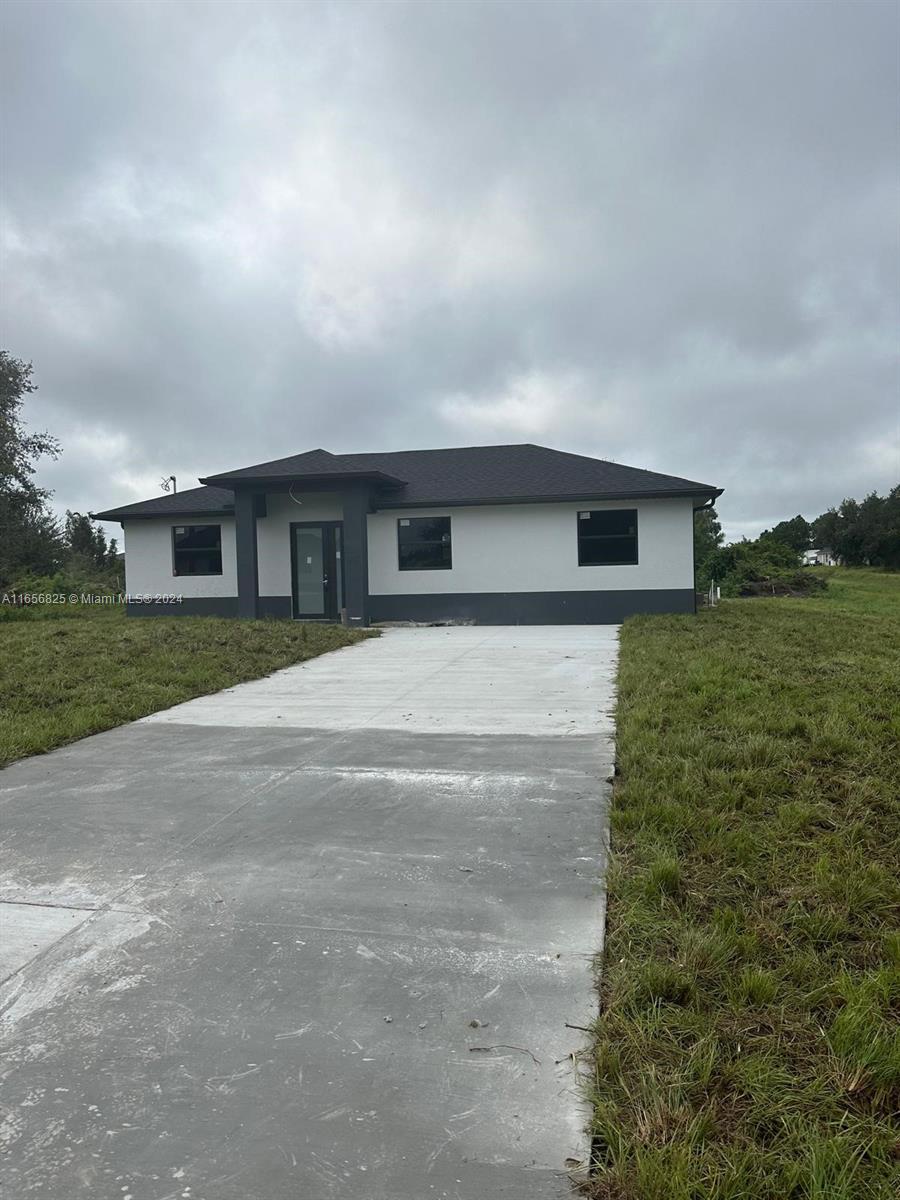 a view of house with yard