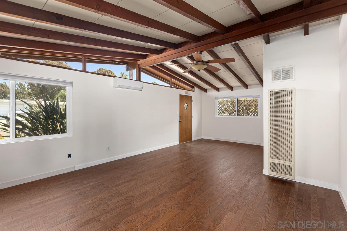 a view of a room with wooden floor and windows