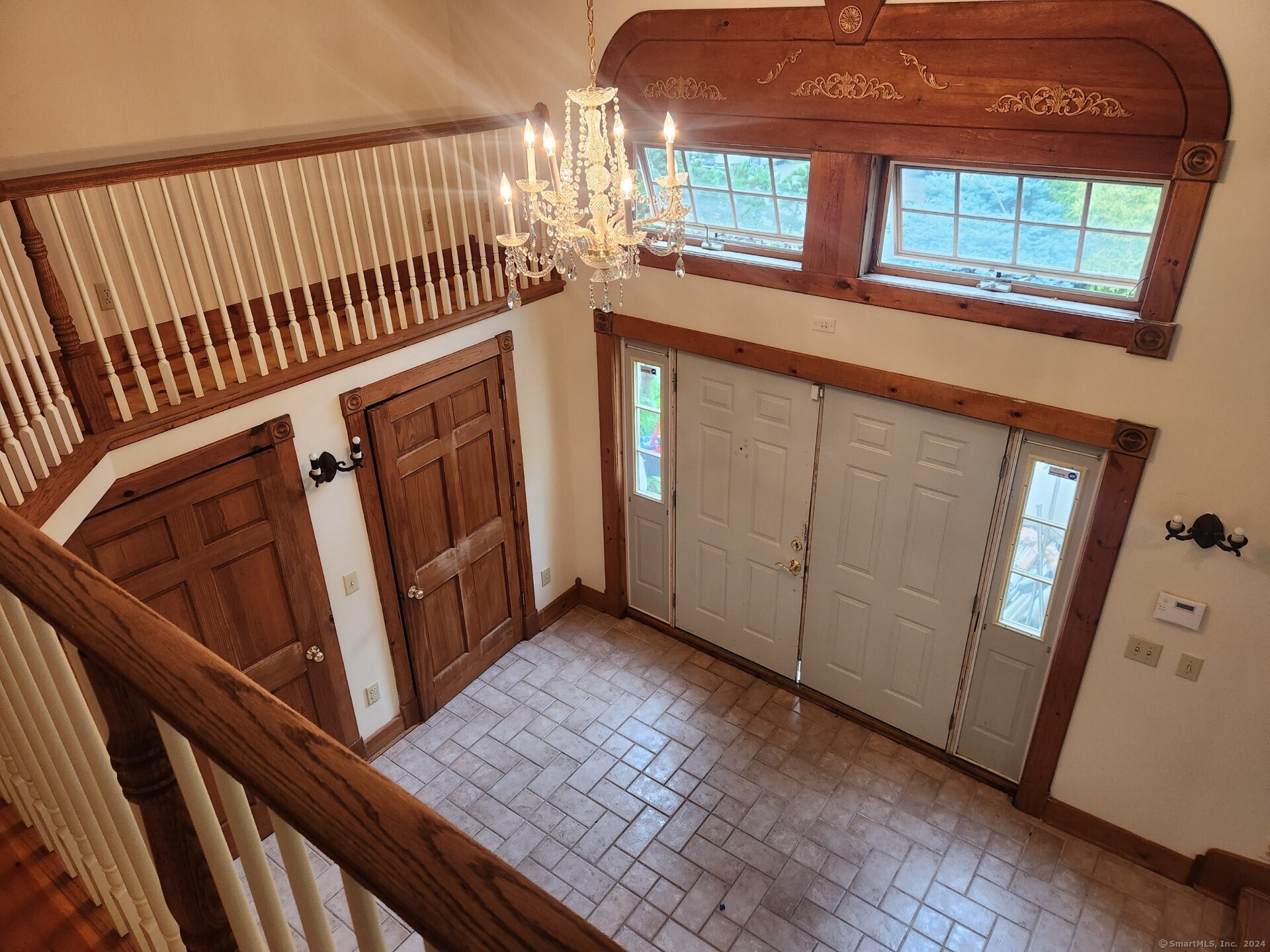 a view of an entryway door with a staircase