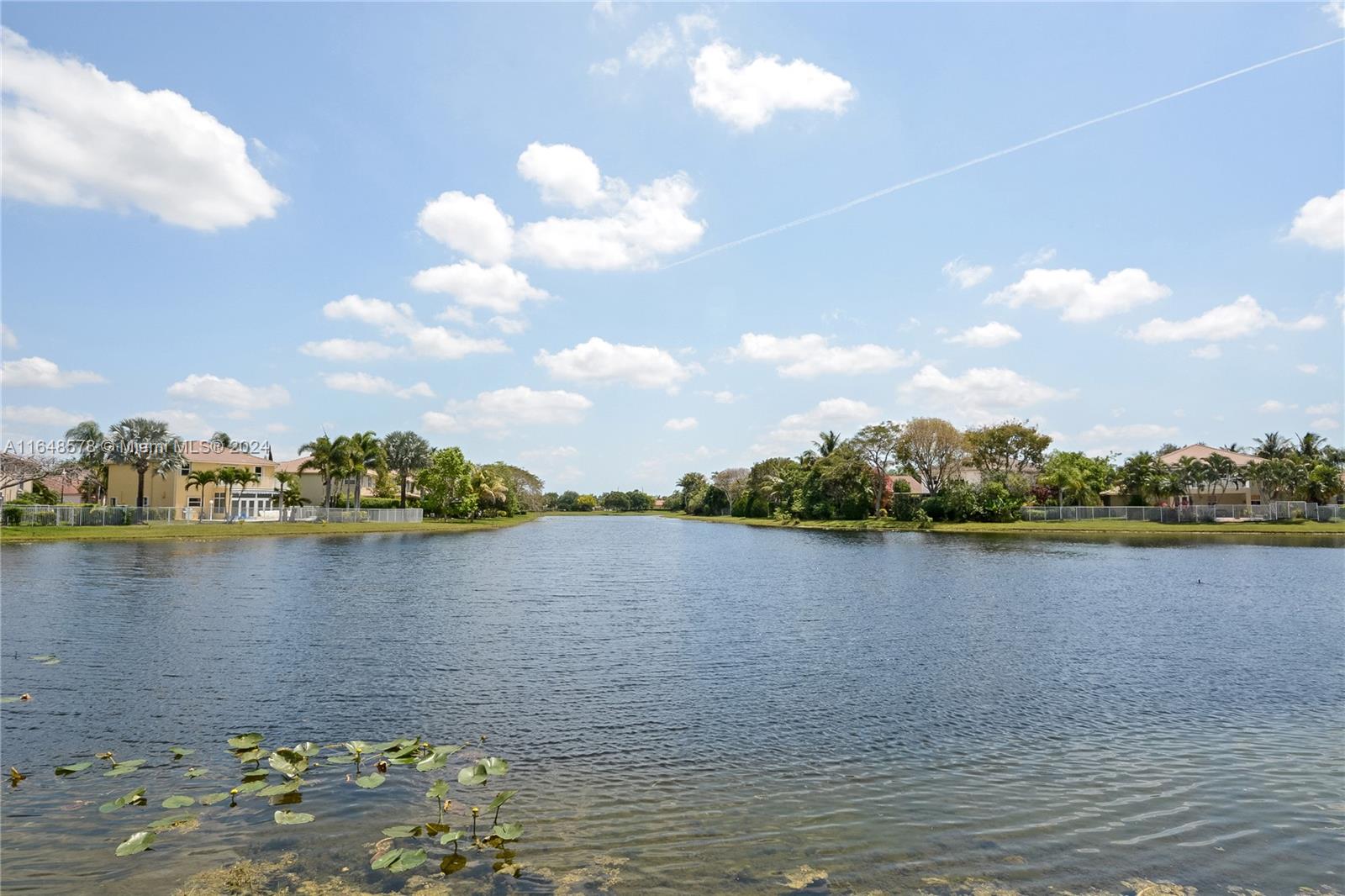 a view of a lake with houses in the back