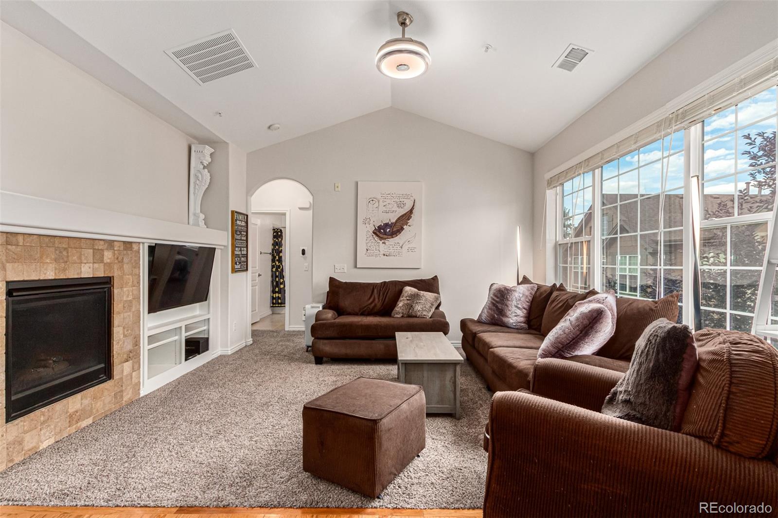 a living room with furniture flat screen tv and a fireplace