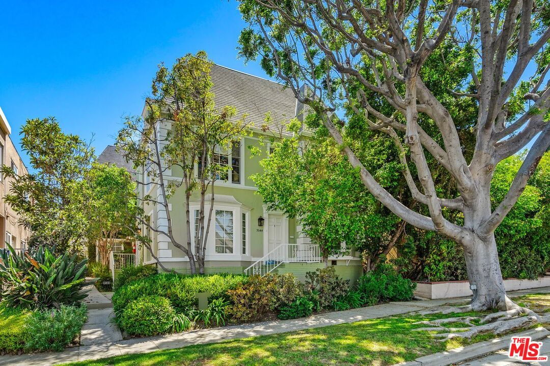 front view of a house with a tree