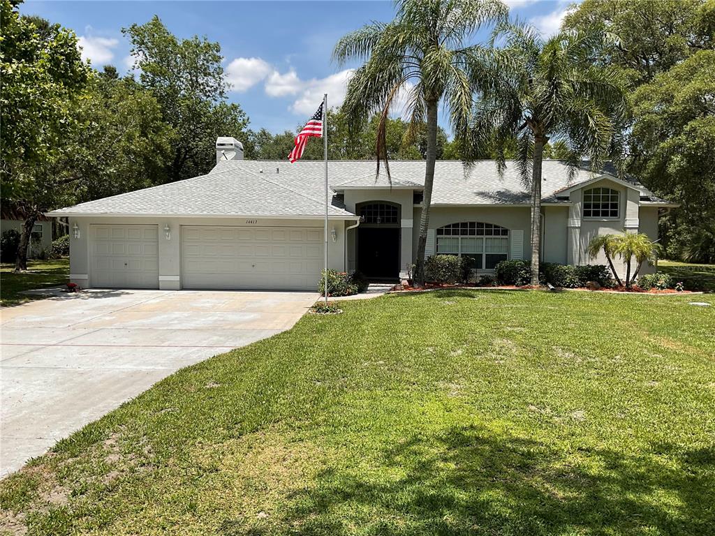 a front view of house with yard and trees