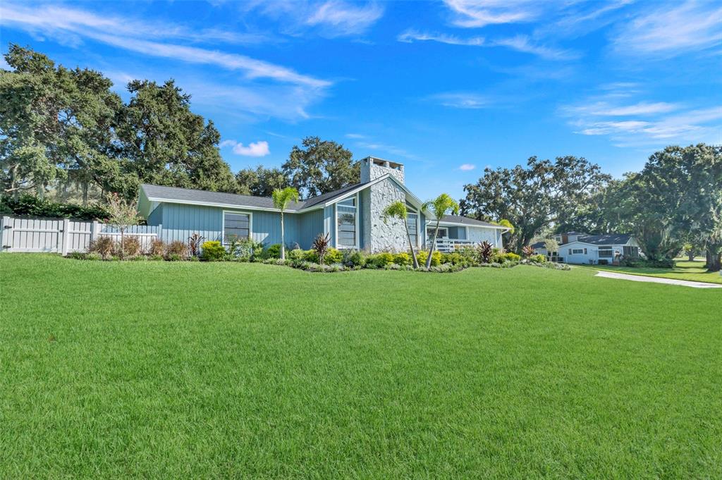 a view of an house with a big yard