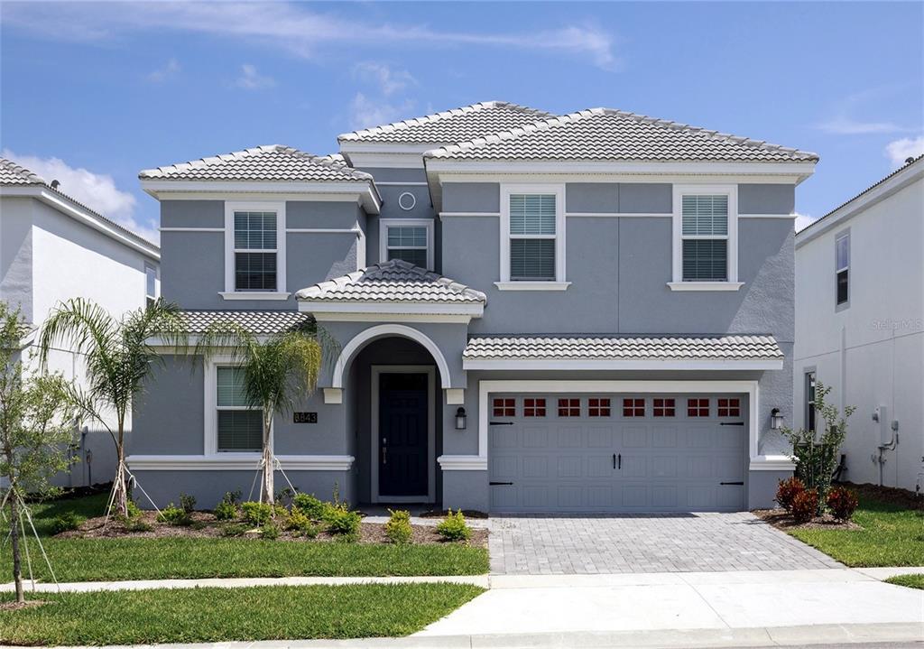 a front view of a house with a yard and garage