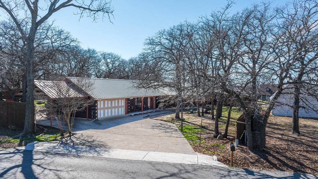 a view of a house with backyard and trees