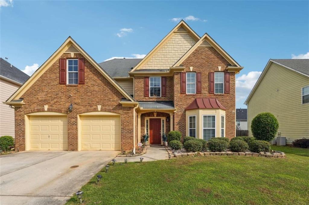 a front view of a house with a yard