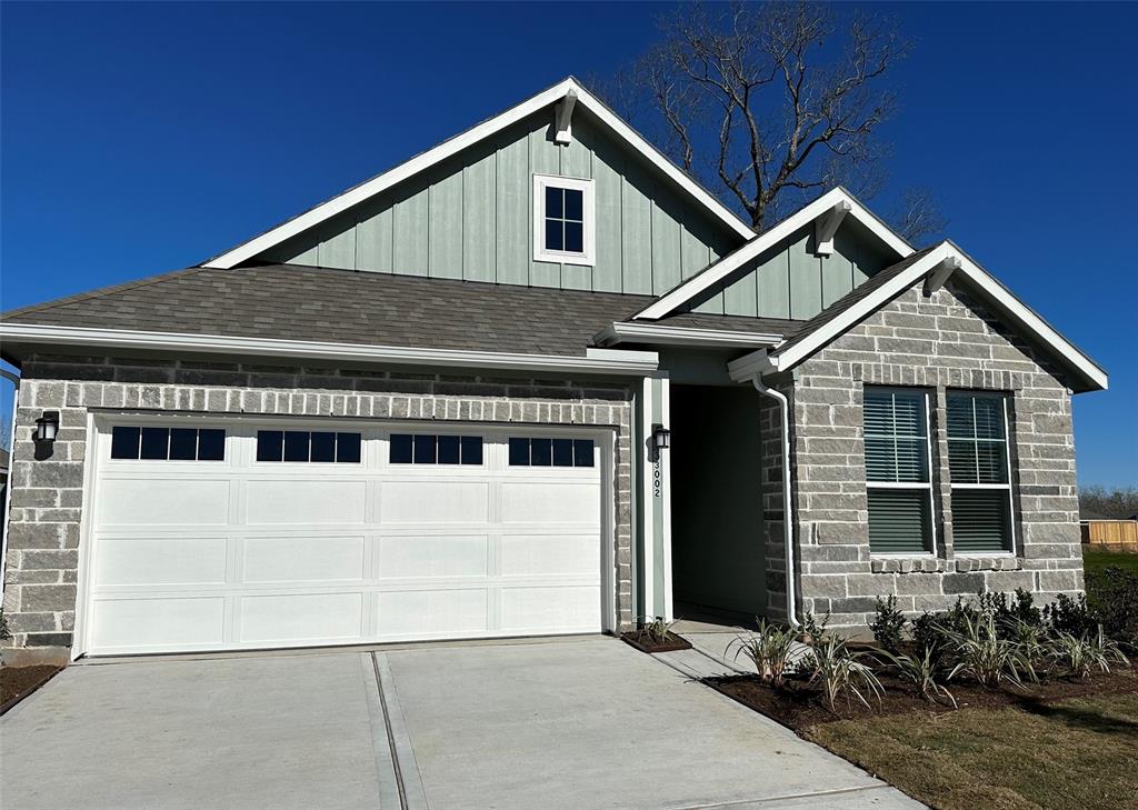 a front view of a house with garage