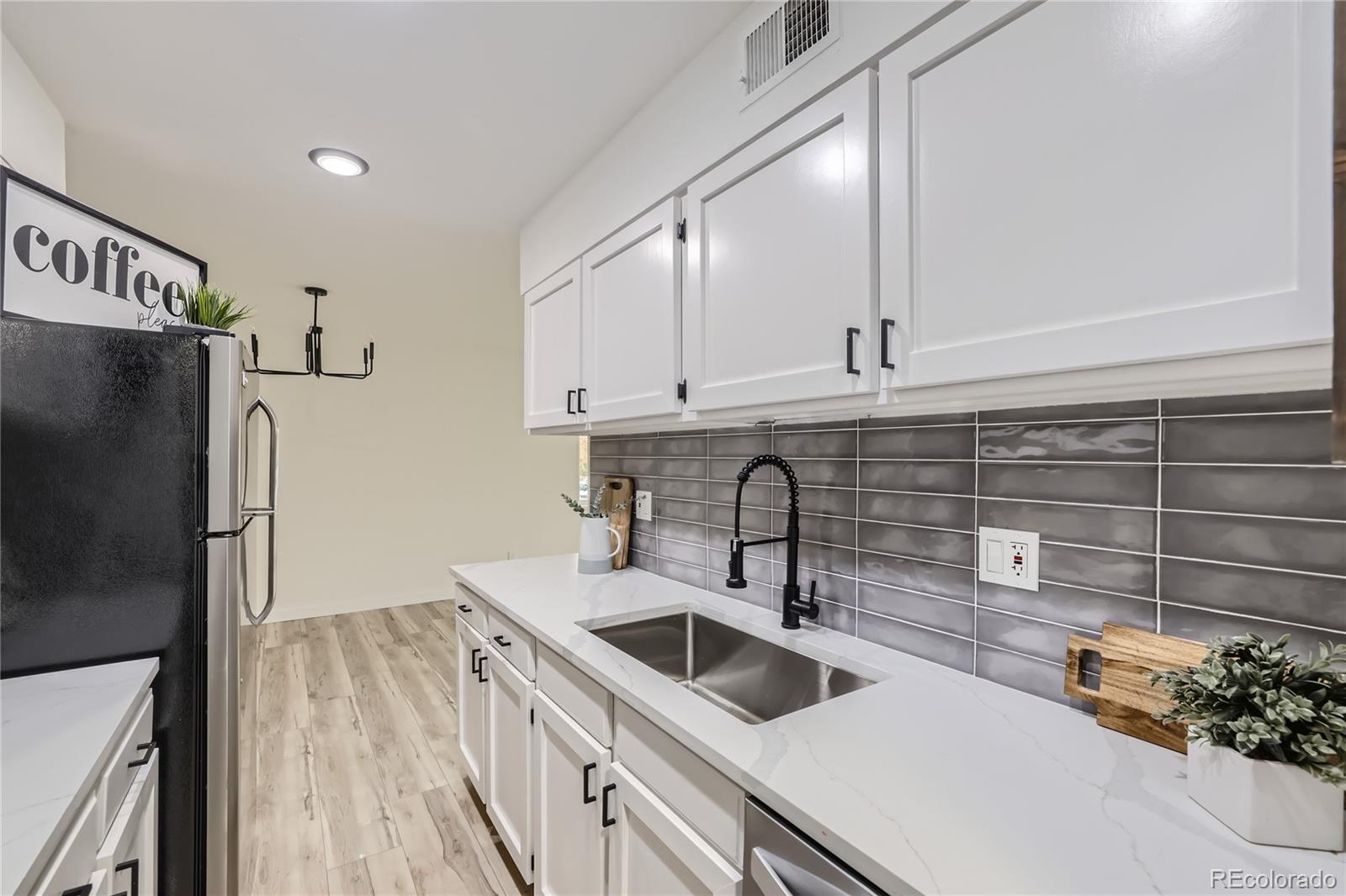 a kitchen with stainless steel appliances a sink stove and refrigerator