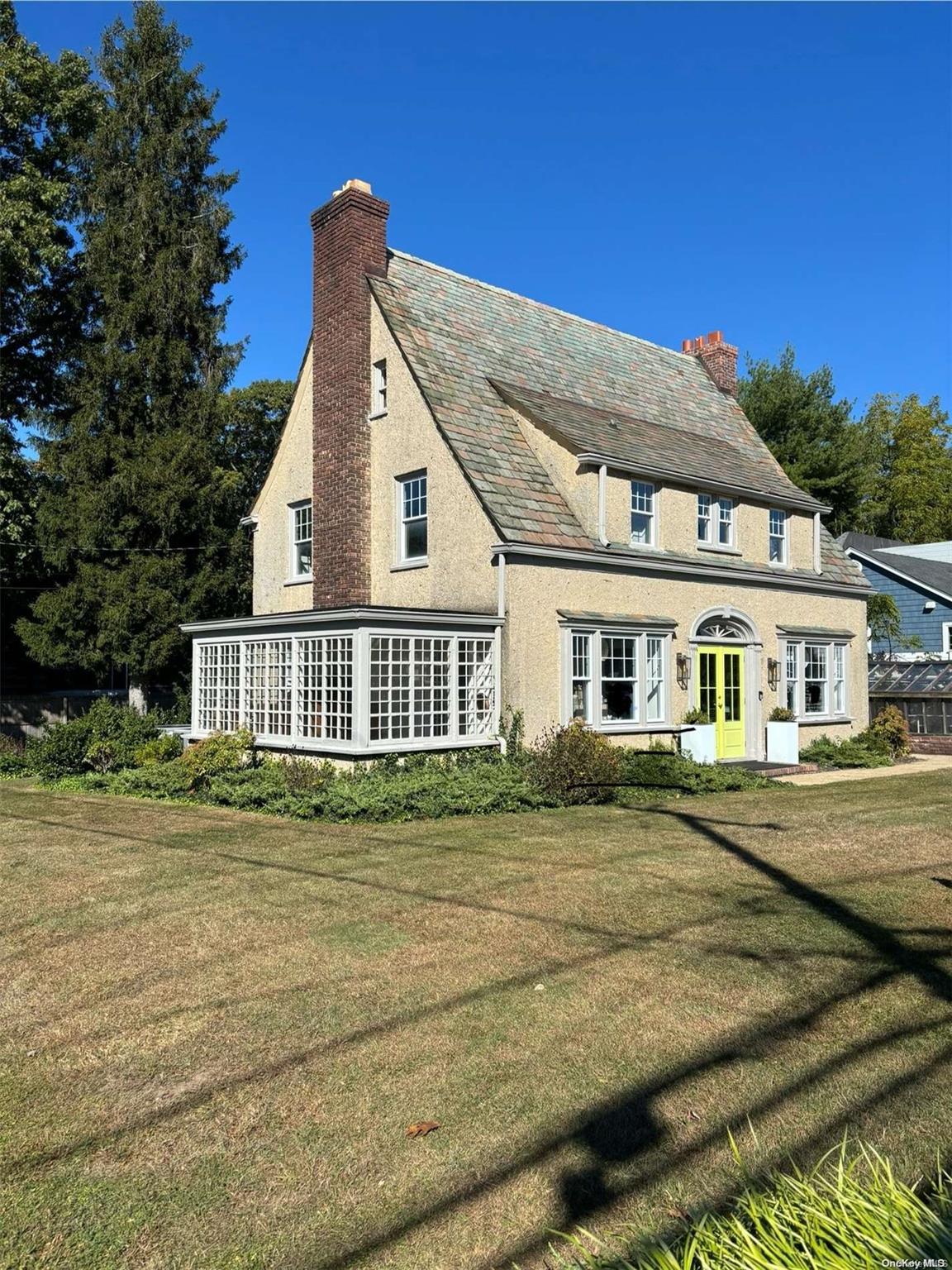 a front view of a house with a garden