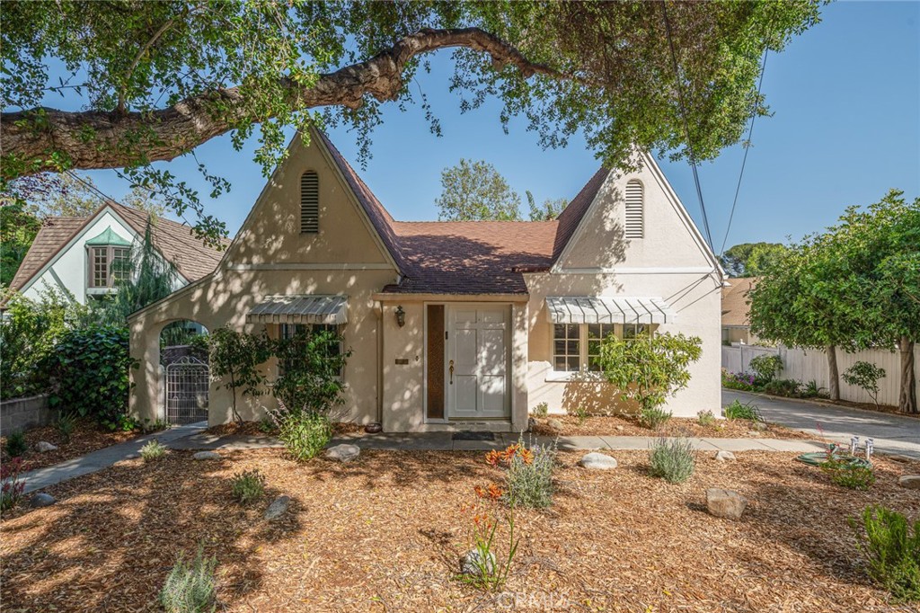 front view of a house with a tree