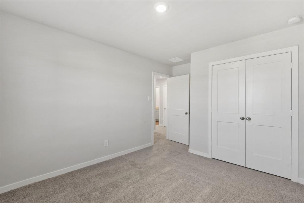 a view of an empty room and closet area