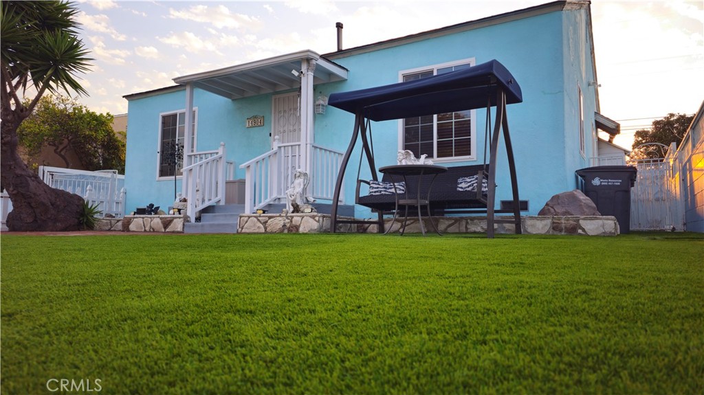 a front view of house with yard and outdoor seating