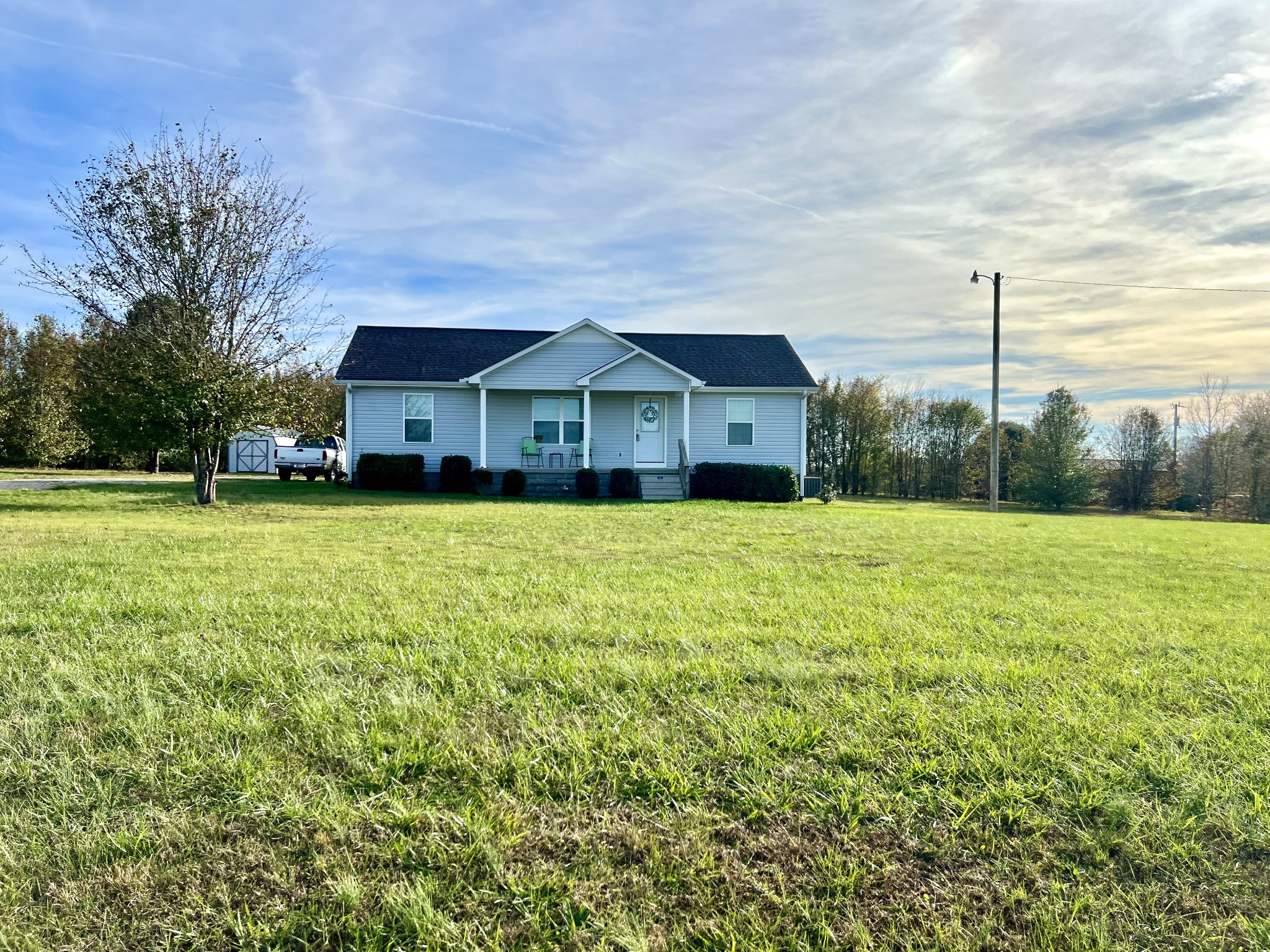 a view of a house with a yard and sitting area