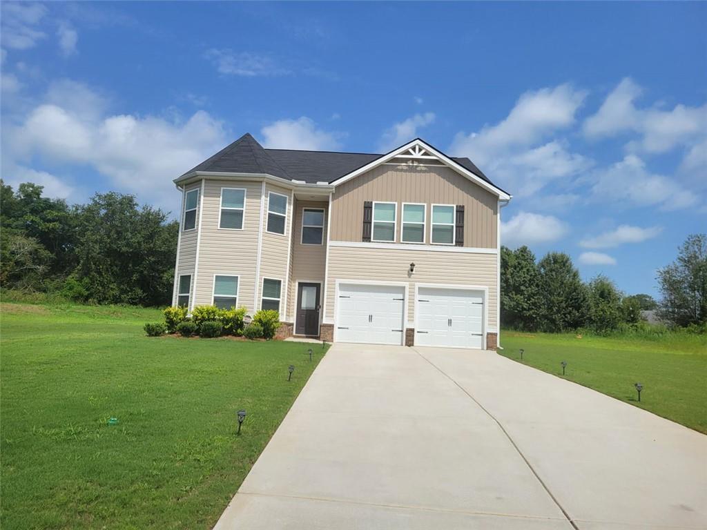 a front view of a house with a yard