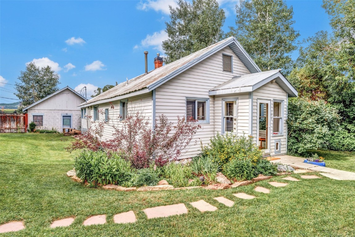 a front view of house with yard and green space