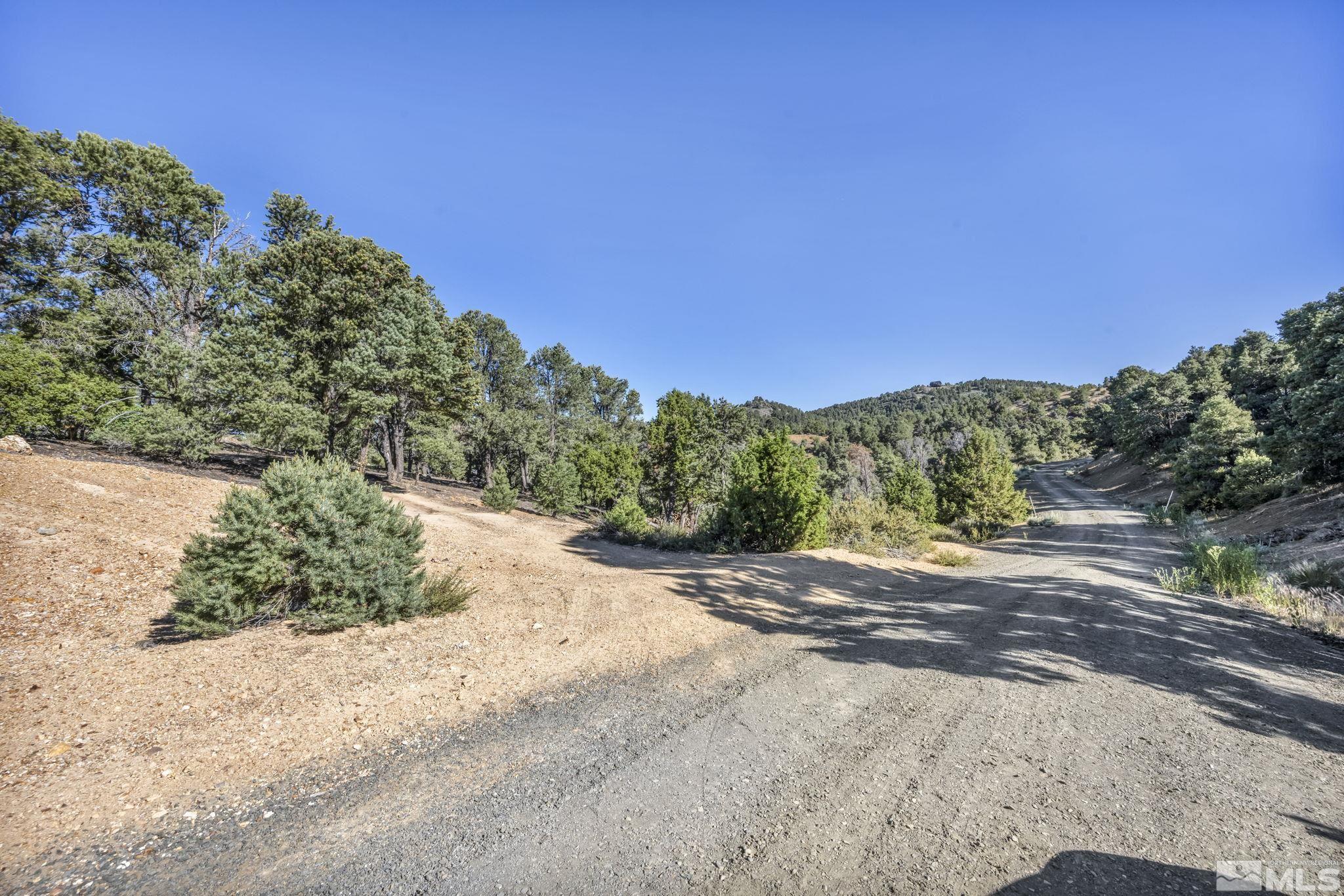 a view of a dirt road with a building in the background