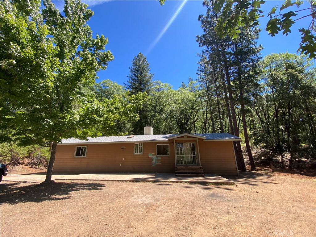 a front view of house with trees around