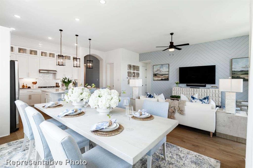 a view of a dining room with furniture and a flat screen tv