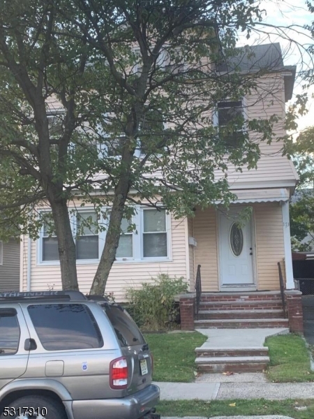 a front view of a house with garage